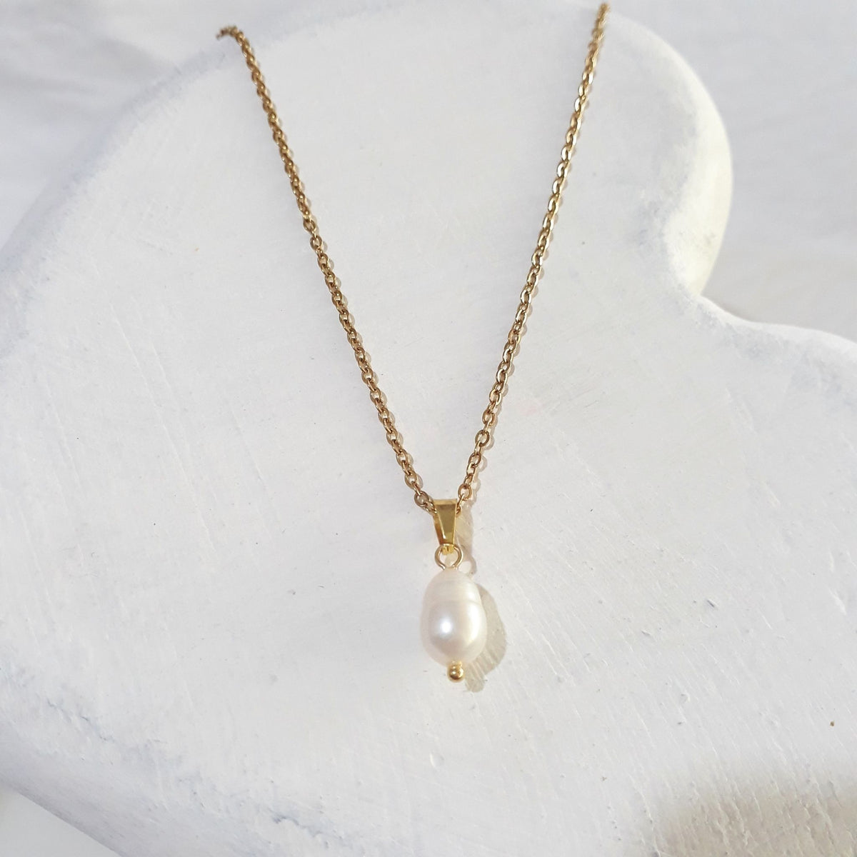 White teardrop freshwater pearl pendant on a gold plated stainless steel chain