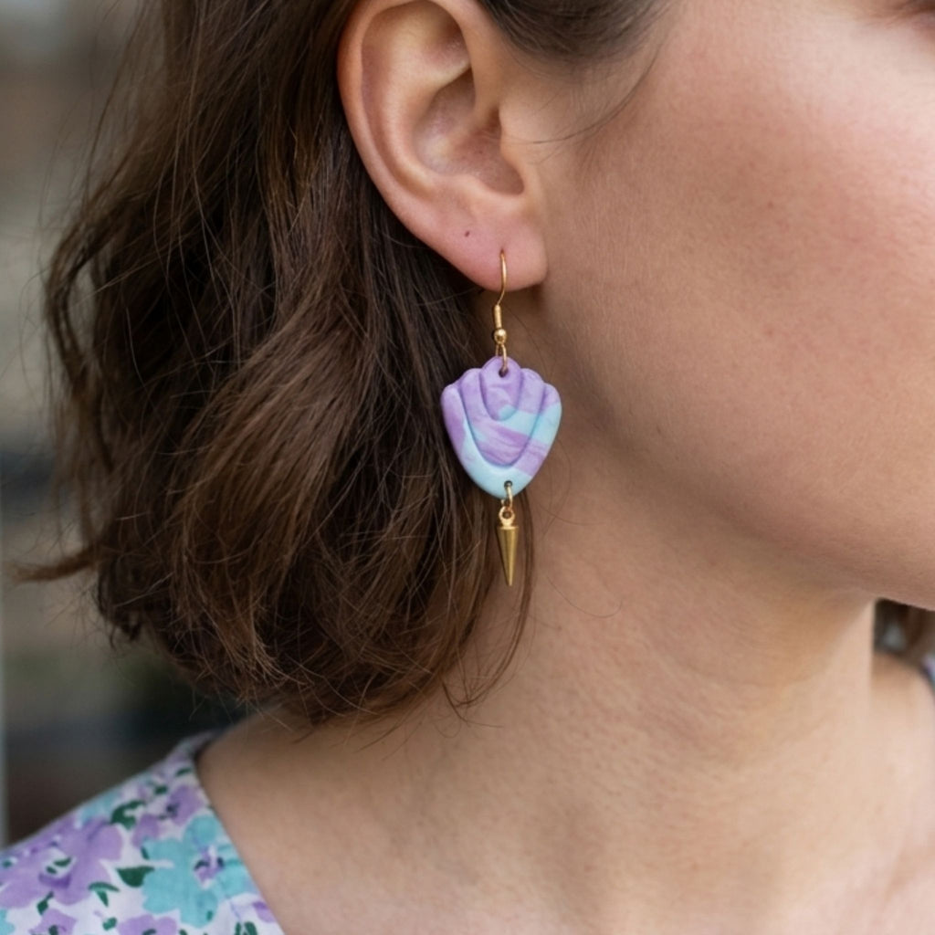 Woman wearing Lilac, Aqua and Lavender Art Deco Clay Earrings with gold plated ear hooks.
