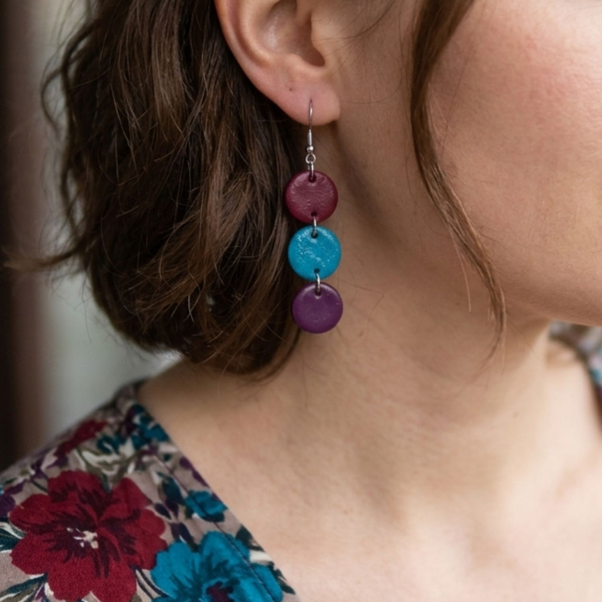 Woman wearing a maroon, Aqua Blue & Plum Cascade Polymer Clay Earrings