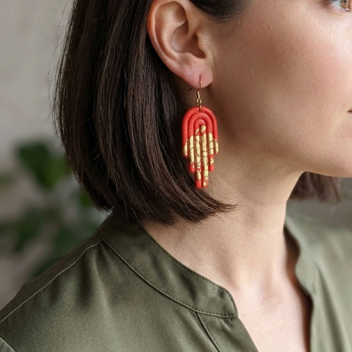 A Woman wearing Dark Orange & Gold Arch Polymer Clay Dangle Earrings