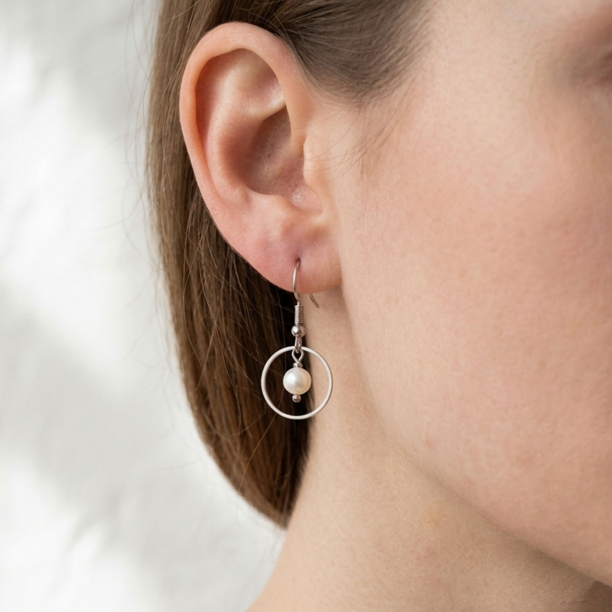 Woman wearing White Freshwater Pearl Open Circle Drop Earrings