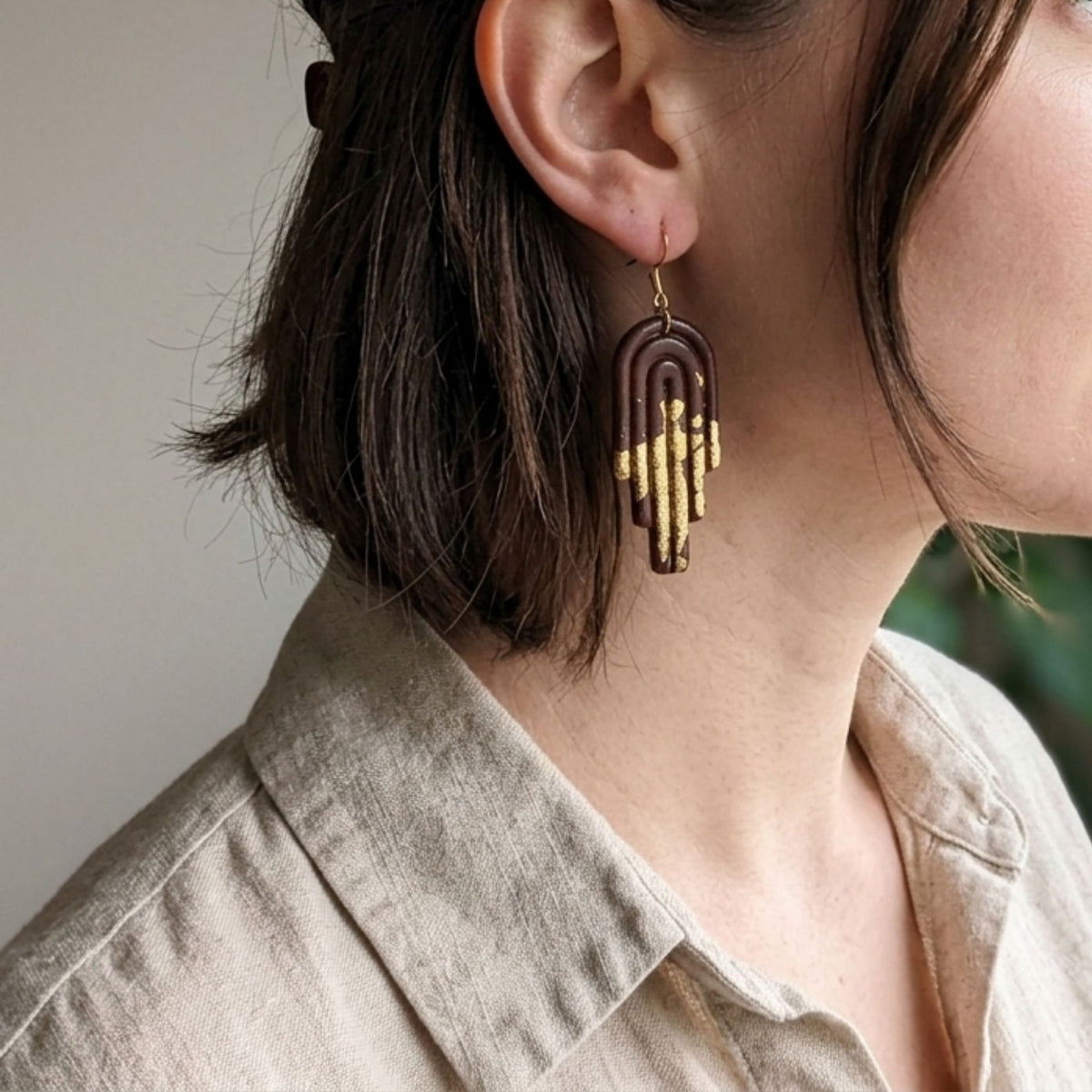 Woman wearing Dark Brown & Gold Arch Polymer Clay Dangle Earrings