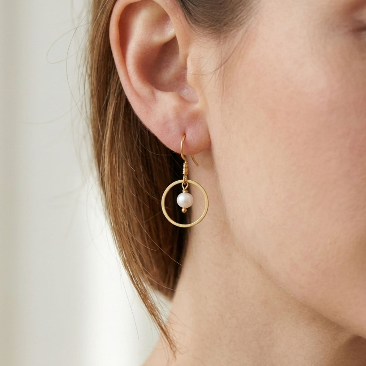 Woman wearing White Freshwater Pearl Gold-Plated Open Circle Drop Earrings