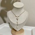 Handmade freshwater pearl Y necklace features an 8 mm off-round white pearl, with four smaller natural white freshwater pearls placed along the chain and drop detail.