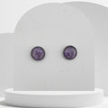 Stainless steel stud earrings with crushed amethyst gemstones in 12mm resin bezel