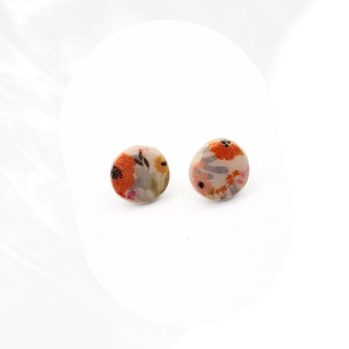 Autumn floral polymer clay stud earrings with orange and yellow flower print sealed with glossy resin and stainless steel pins