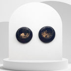 Handmade black polymer clay stud earrings with gold leaf and resin finish