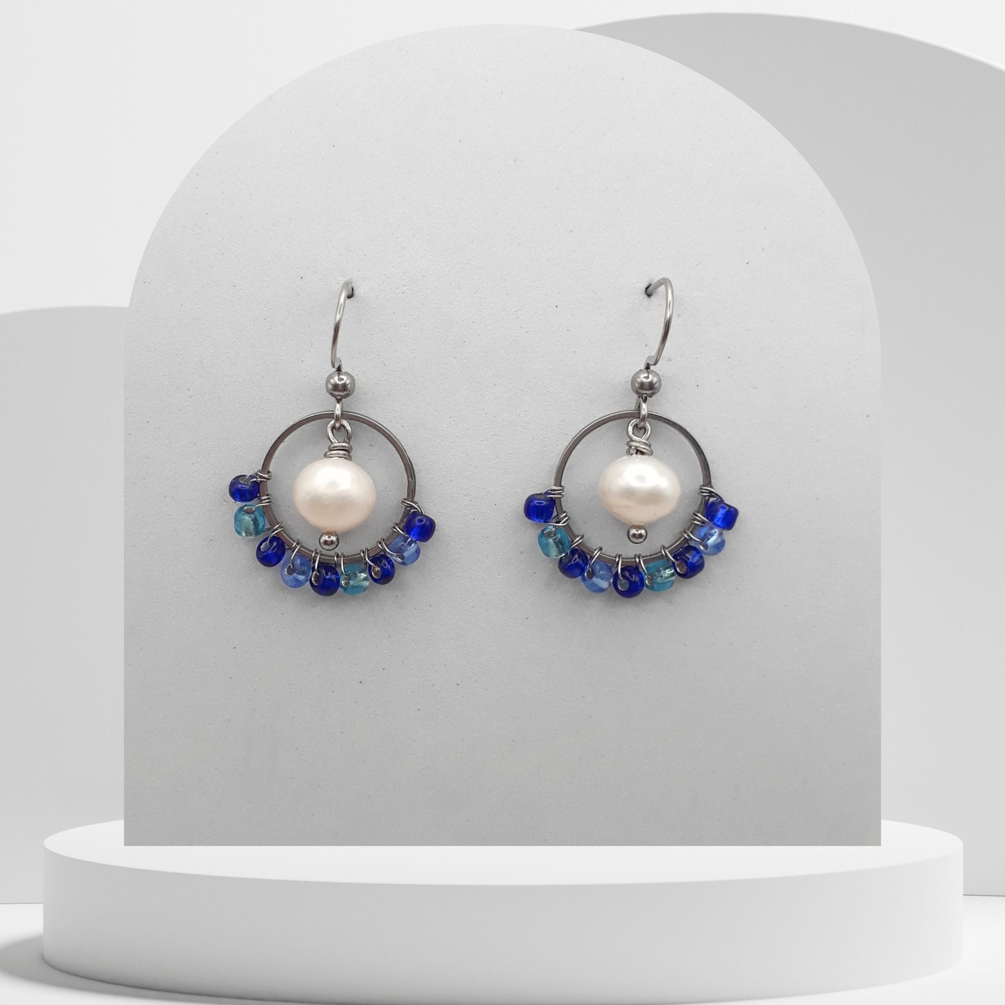 White pearl drop earrings with blue beaded stainless steel circle and hook