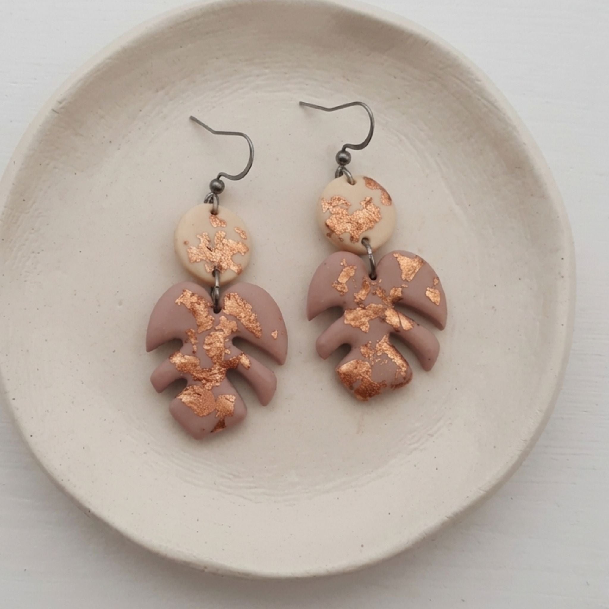 Mauve polymer clay Monstera leaf earrings with copper metallic flecks and stainless steel shepherd ear hooks