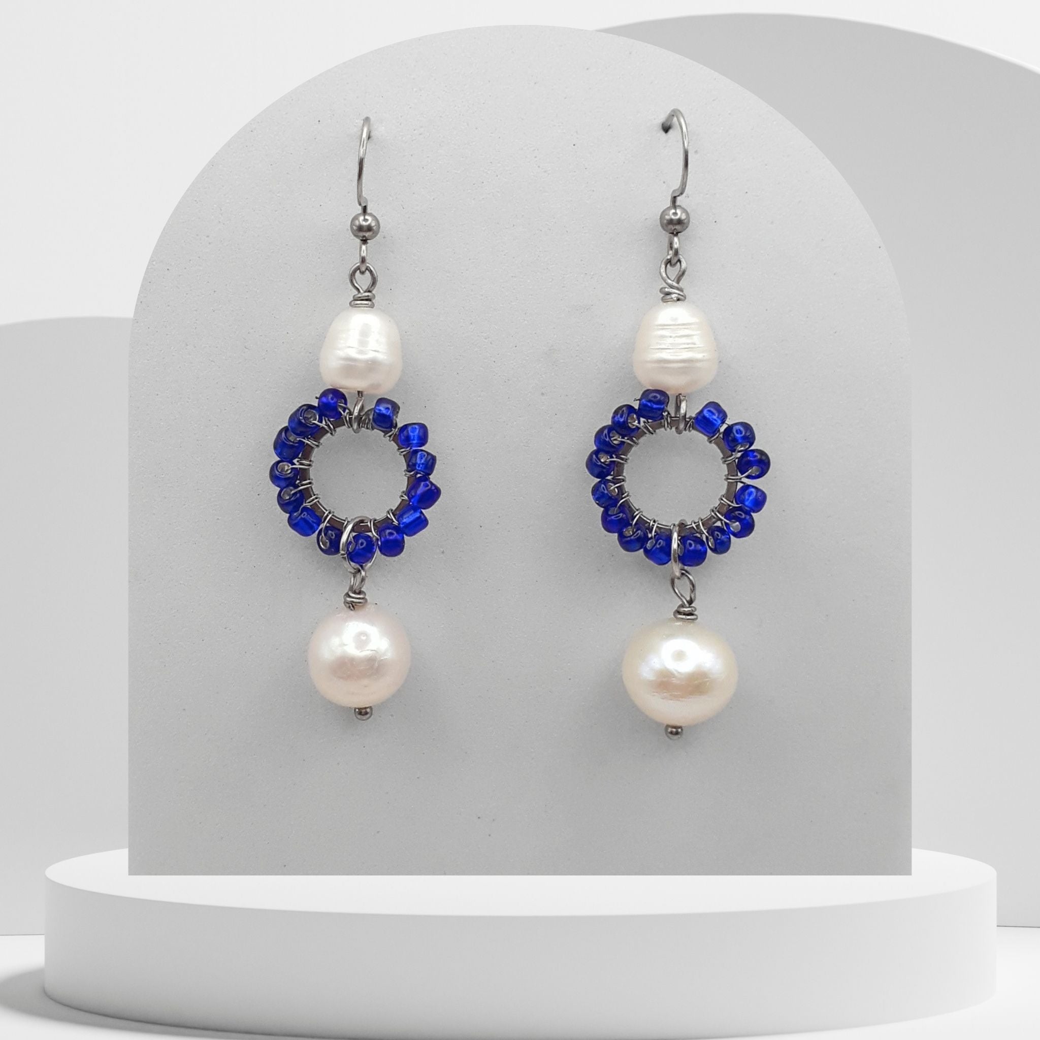 Double white pearl dangle earrings with dark blue beaded circle and stainless steel hooks