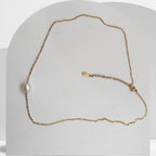 Gold plated stainless steel necklace with floating white freshwater pearls on cable chain