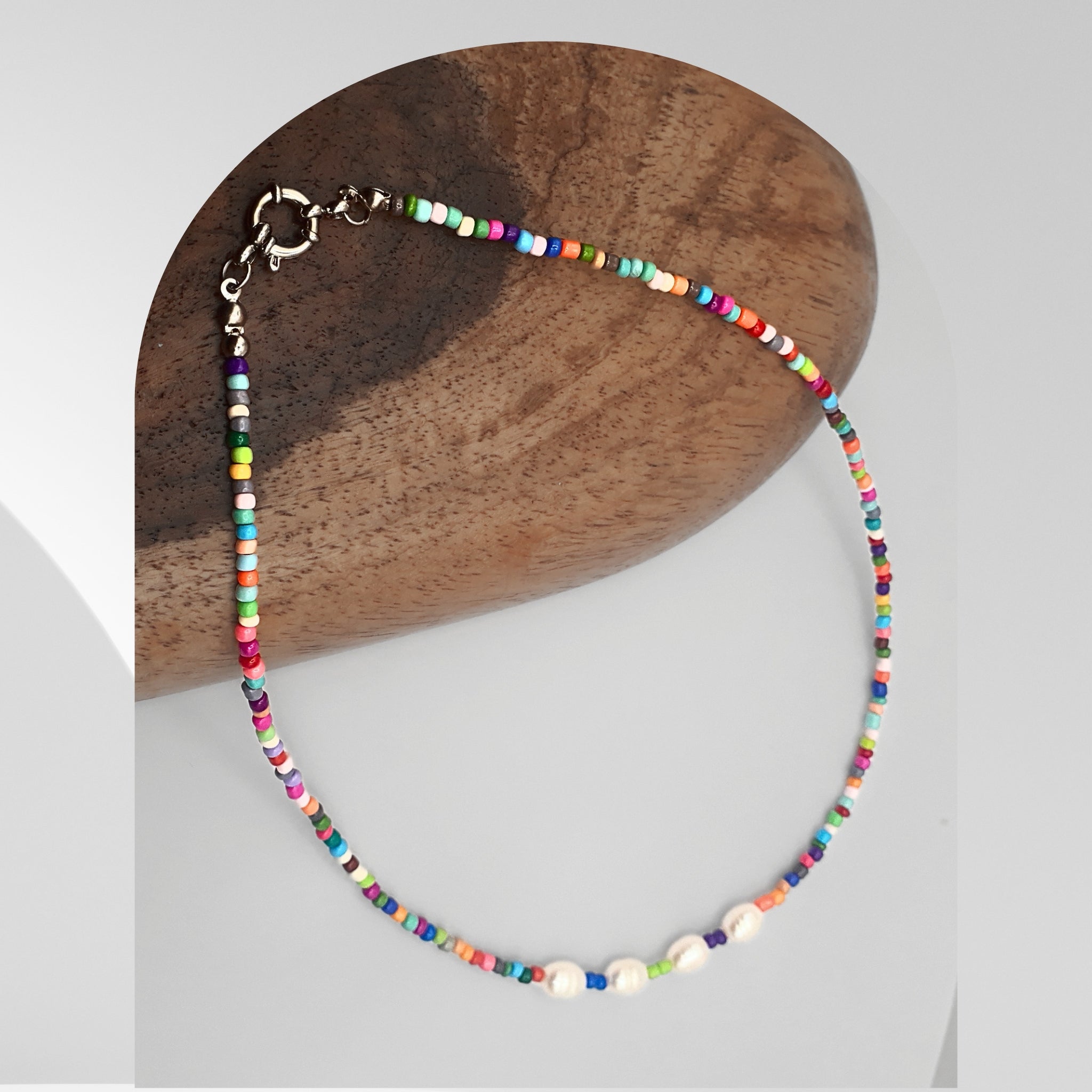 Handmade colourful beaded necklace featuring freshwater pearls and multicoloured seed beads with a spring ring clasp.