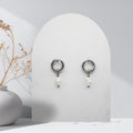 Handmade 316L stainless steel 12 mm huggie hoop earrings with removable natural white freshwater rice pearl charms.