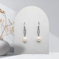 Handmade stainless steel paperclip drop earrings with 7 mm natural white freshwater pearls and stainless steel shepherd ear hooks.