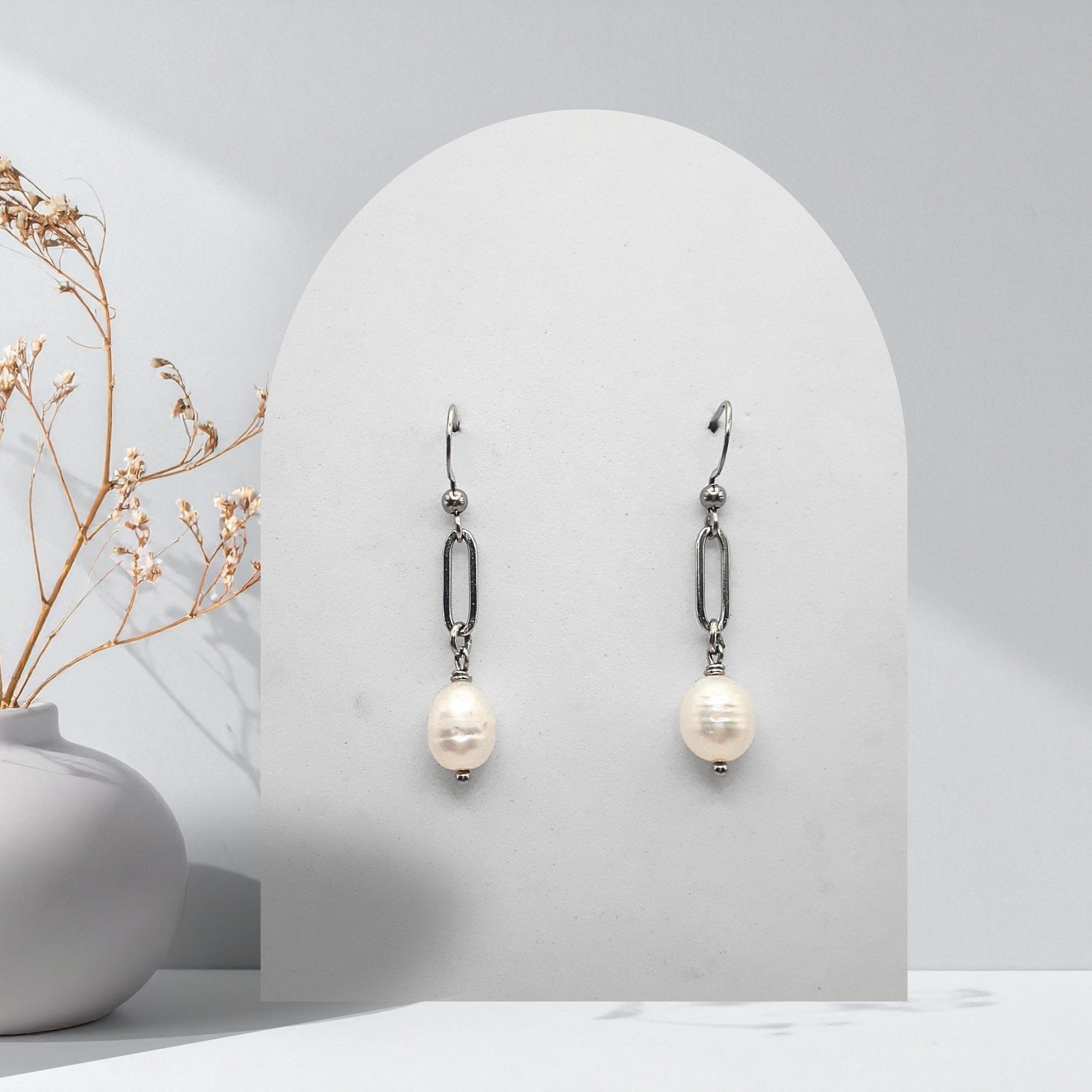 Handmade stainless steel paperclip drop earrings with 7 mm natural white freshwater pearls and stainless steel shepherd ear hooks.