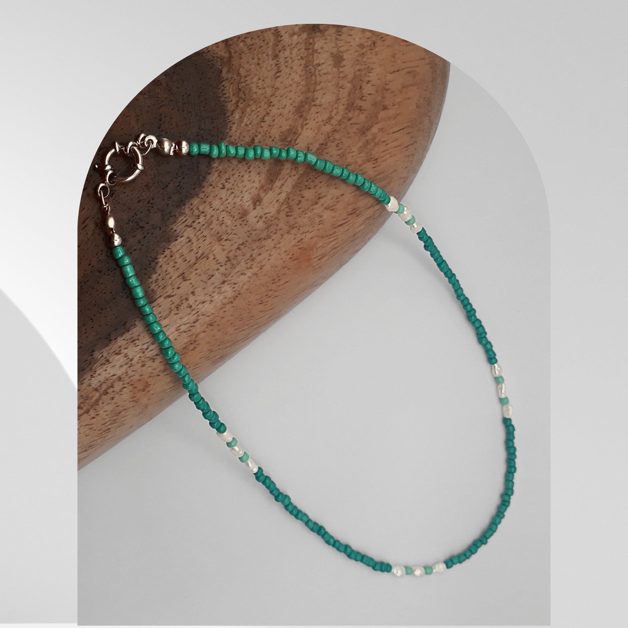Handmade necklace featuring freshwater rice pearls and turquoise glass beads with a stainless steel spring ring clasp.