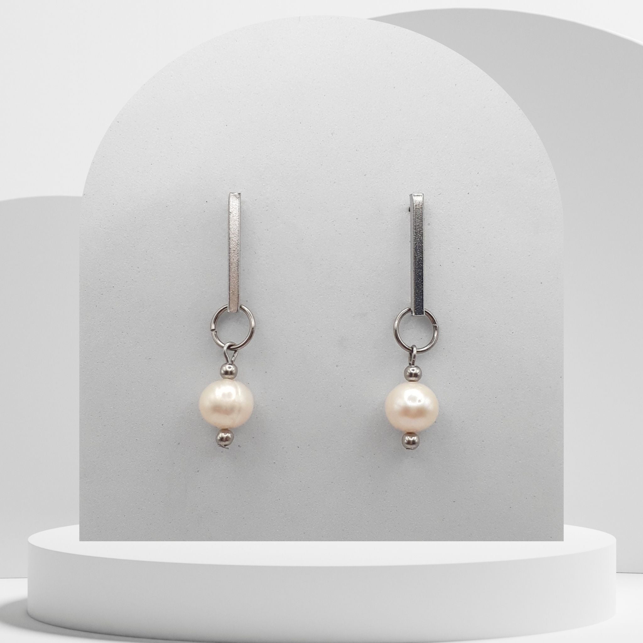 White freshwater pearl drop earrings with stainless steel circle and square stud