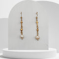Handmade white freshwater pearl dangle earrings with gold cross and heart charms