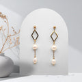 Handmade gold-plated stainless steel dangle earrings with natural white freshwater pearls, open diamond connector, and 4 mm ball stud earrings.