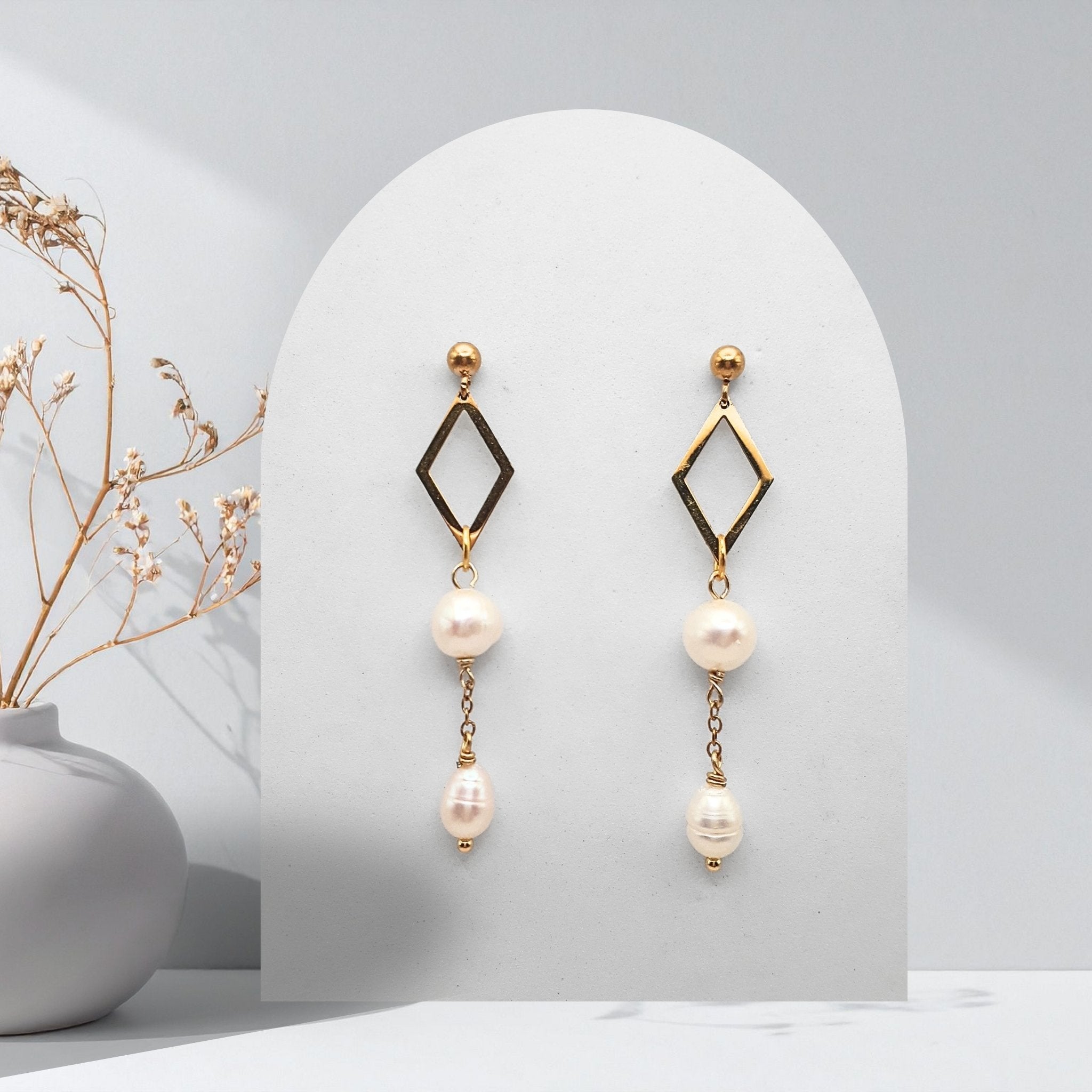Handmade gold-plated stainless steel dangle earrings with natural white freshwater pearls, open diamond connector, and 4 mm ball stud earrings.