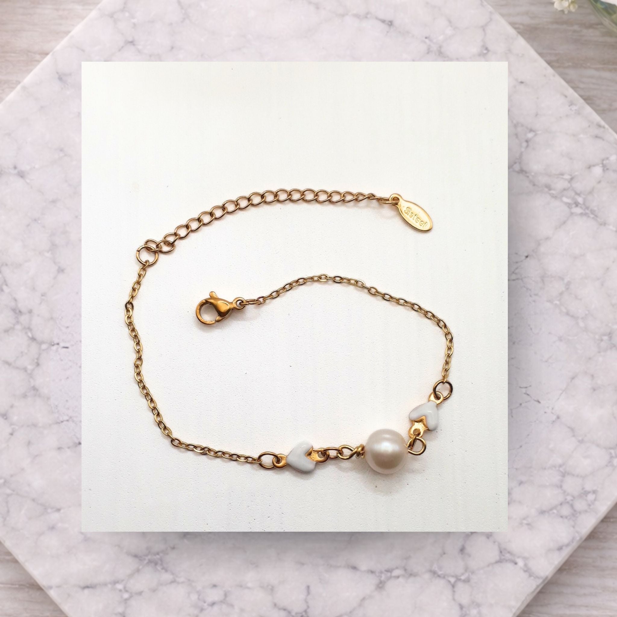 Freshwater pearl gold plated stainless steel bracelet with little hearts
