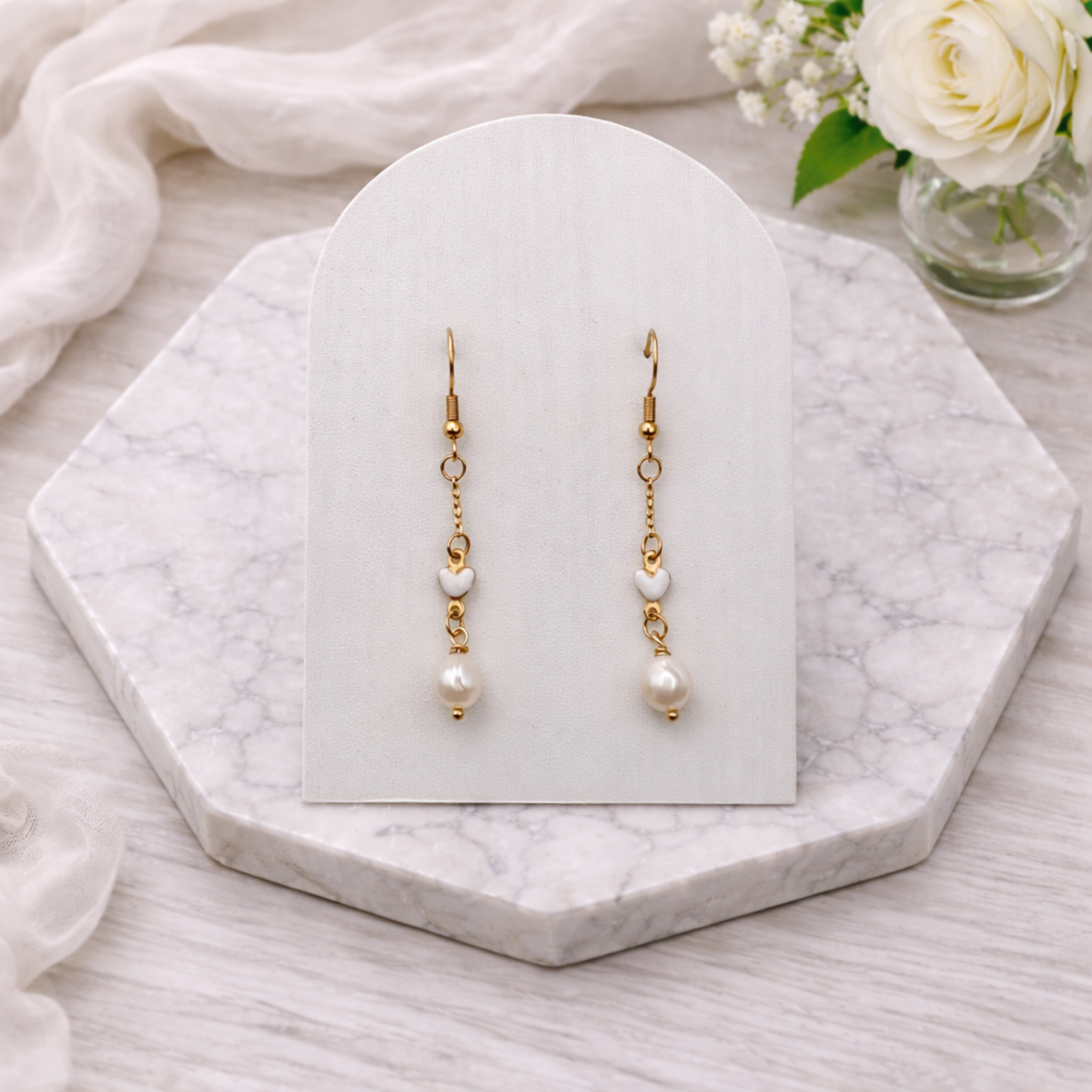 Gold-plated stainless steel heart and pearl drop earrings with 7mm freshwater pearl and white ceramic heart detail, 3cm dangle design