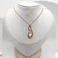 Handmade gold plated stainless steel necklace with freshwater pearl encased in resin teardrop pendant