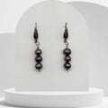 Handmade drop earrings with three green and brown freshwater pearls on stainless steel hooks