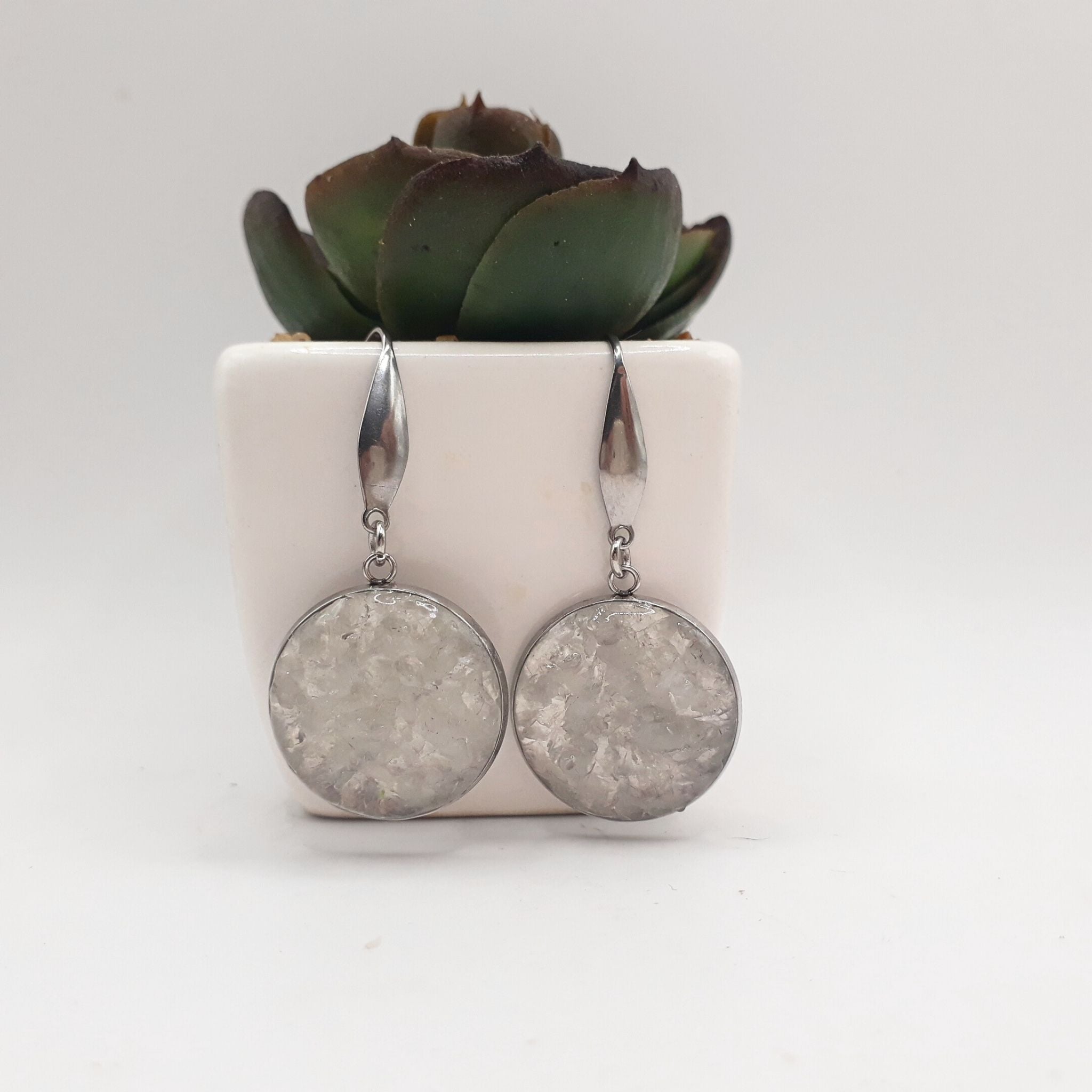 Handcrafted drop earrings with natural crushed clear quartz set in large 20 mm stainless steel bezels, sealed in glossy resin and finished with elegant stainless steel hooks.