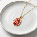 Handmade gold plated stainless steel necklace with crushed red coral teardrop pendant