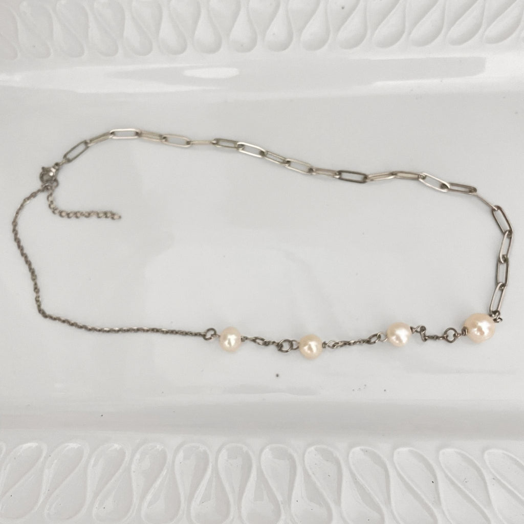 Handmade Freshwater Pearl & Paperclip Chain Necklace on a white ceramic plate.