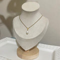 White Freshwater Pearl Teardrop Necklace – Gold-Plated Stainless Steel on a cream bust