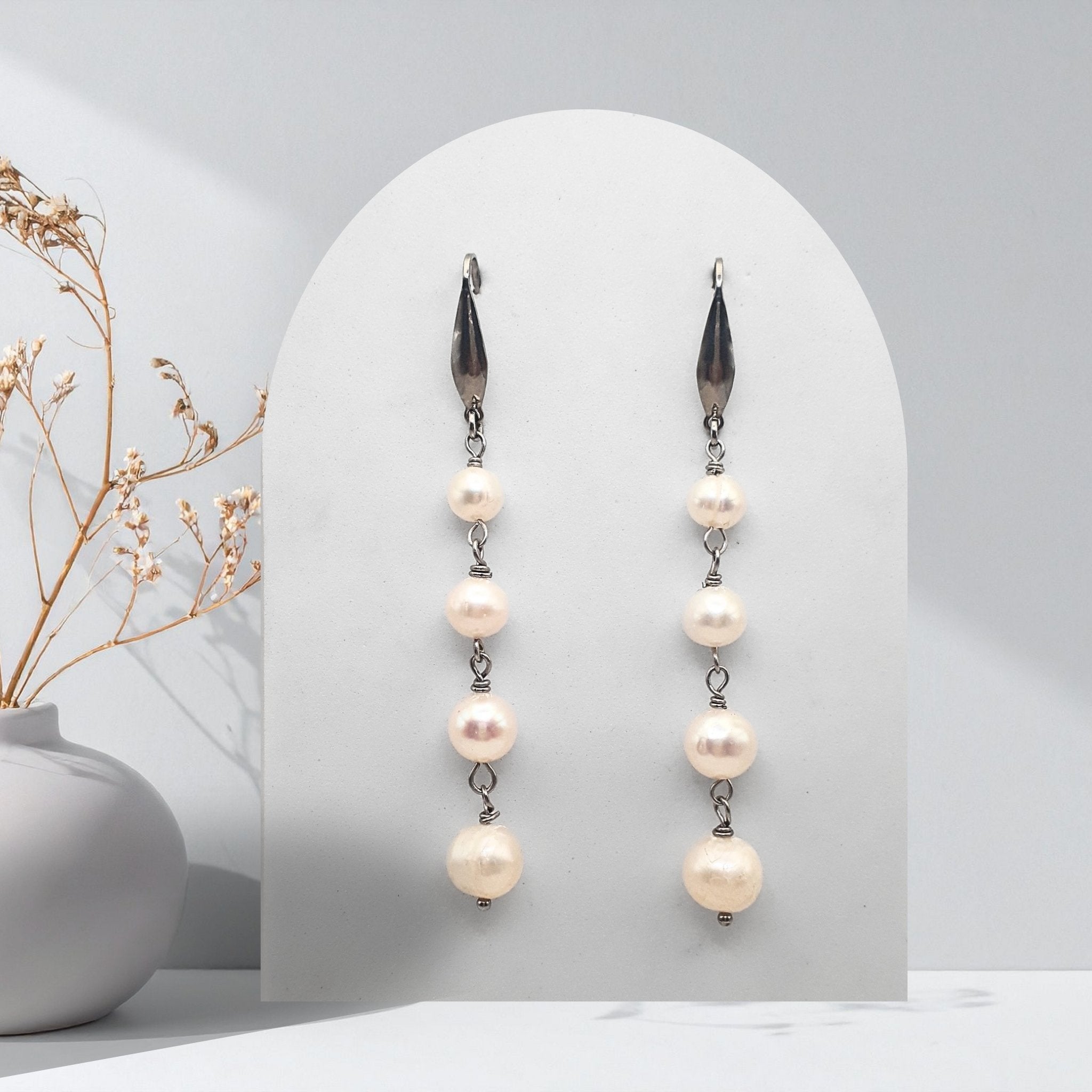 Handmade stainless steel cascade earrings featuring natural white freshwater pearls in graduating 6 mm, 7 mm, 8 mm and 9 mm sizes.