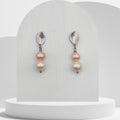 Handmade drop earrings with peach and white freshwater pearls on stainless steel leaf studs
