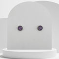 Small stainless steel stud earrings with crushed amethyst gemstones in 7mm resin bezel