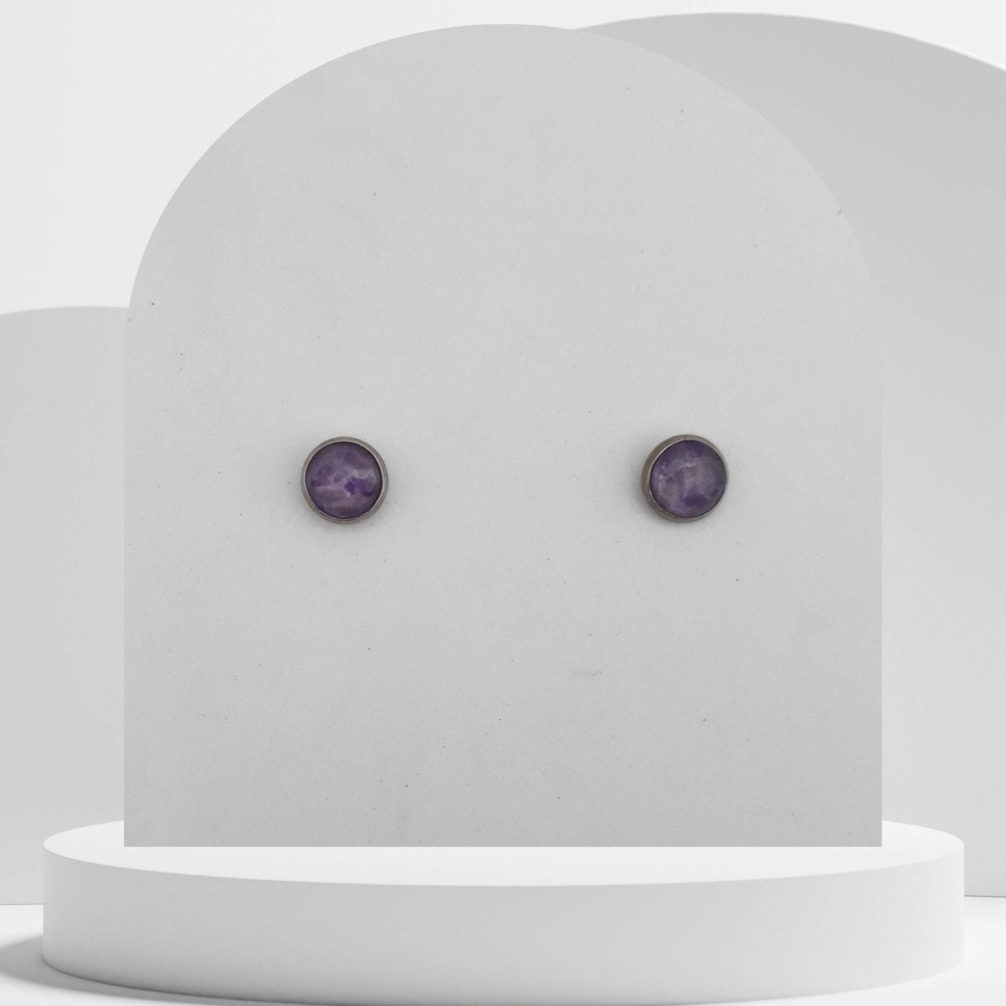 Small stainless steel stud earrings with crushed amethyst gemstones in 7mm resin bezel