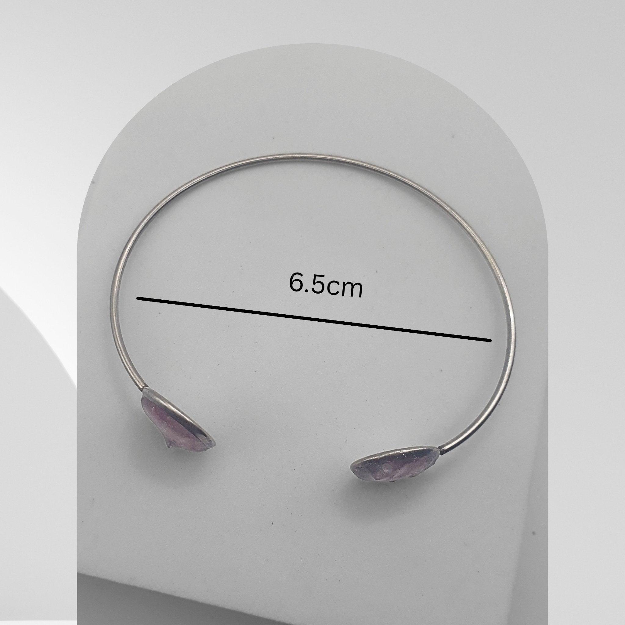 Handmade stainless steel open cuff bangle with crushed Pink Aura Quartz sealed in resin