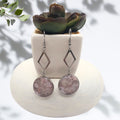 Handmade stainless steel dangle earrings with crushed pink aura quartz resin bezel
