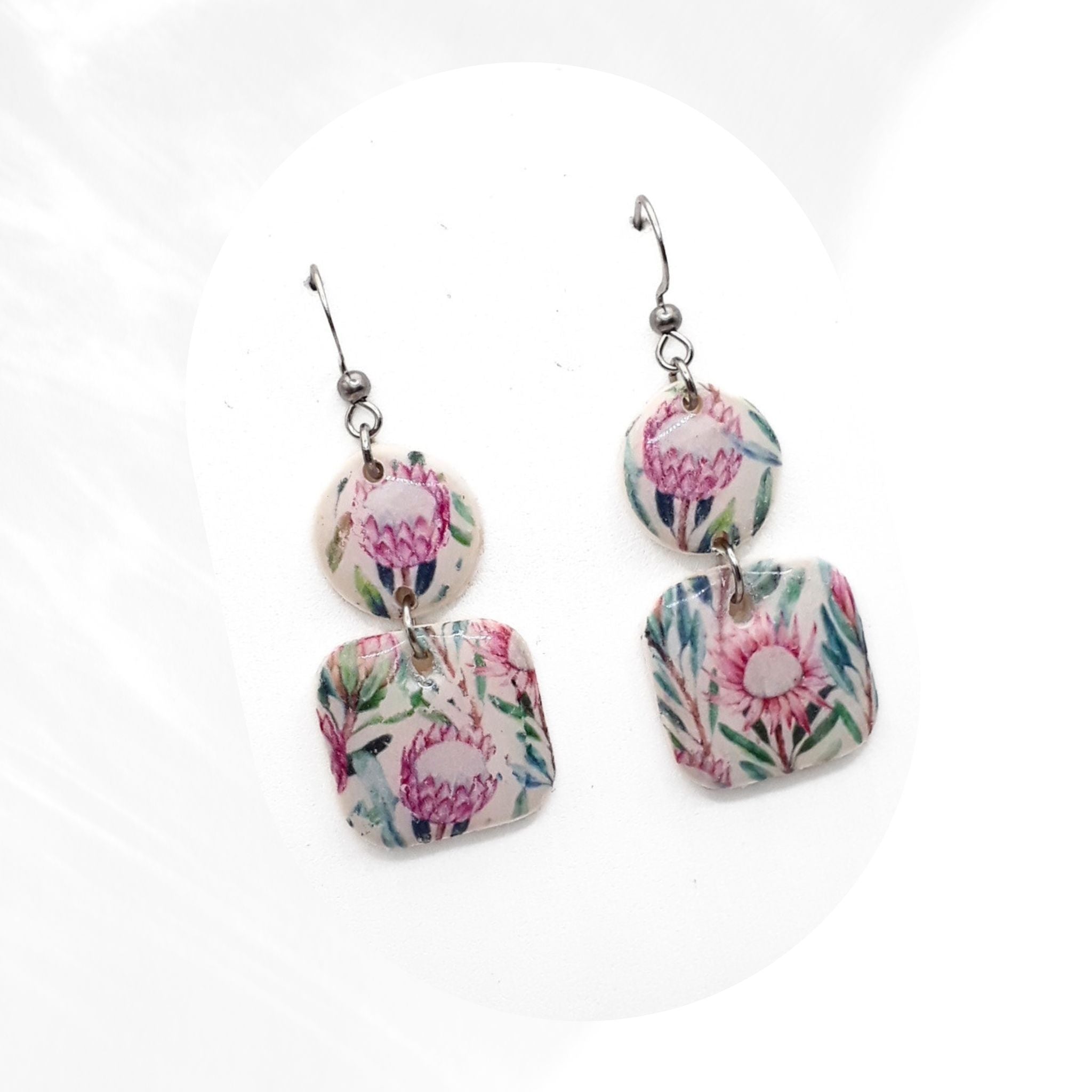 Handmade protea print polymer clay drop earrings sealed with glossy resin finish, lightweight floral earrings with stainless steel hooks