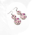 Handmade purple floral polymer clay drop earrings with double round design sealed in glossy resin and stainless steel hooks