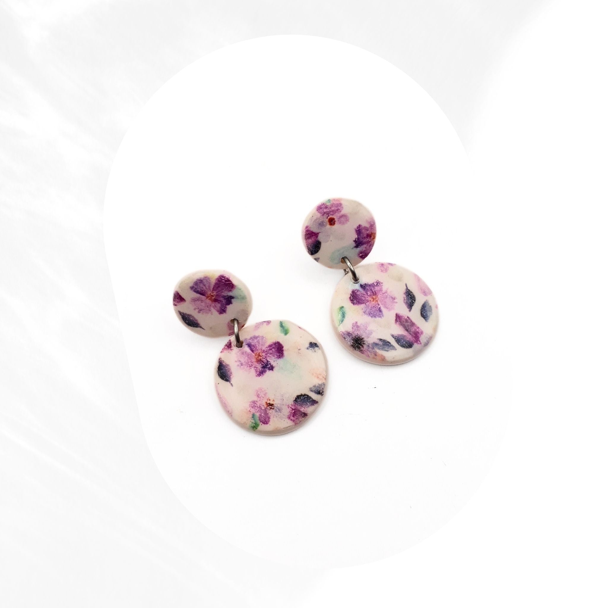 Purple floral polymer clay stud drop earrings with double round design sealed with glossy resin and stainless steel ear pins