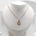 Handmade gold plated stainless steel necklace with freshwater rice pearls in resin teardrop pendant