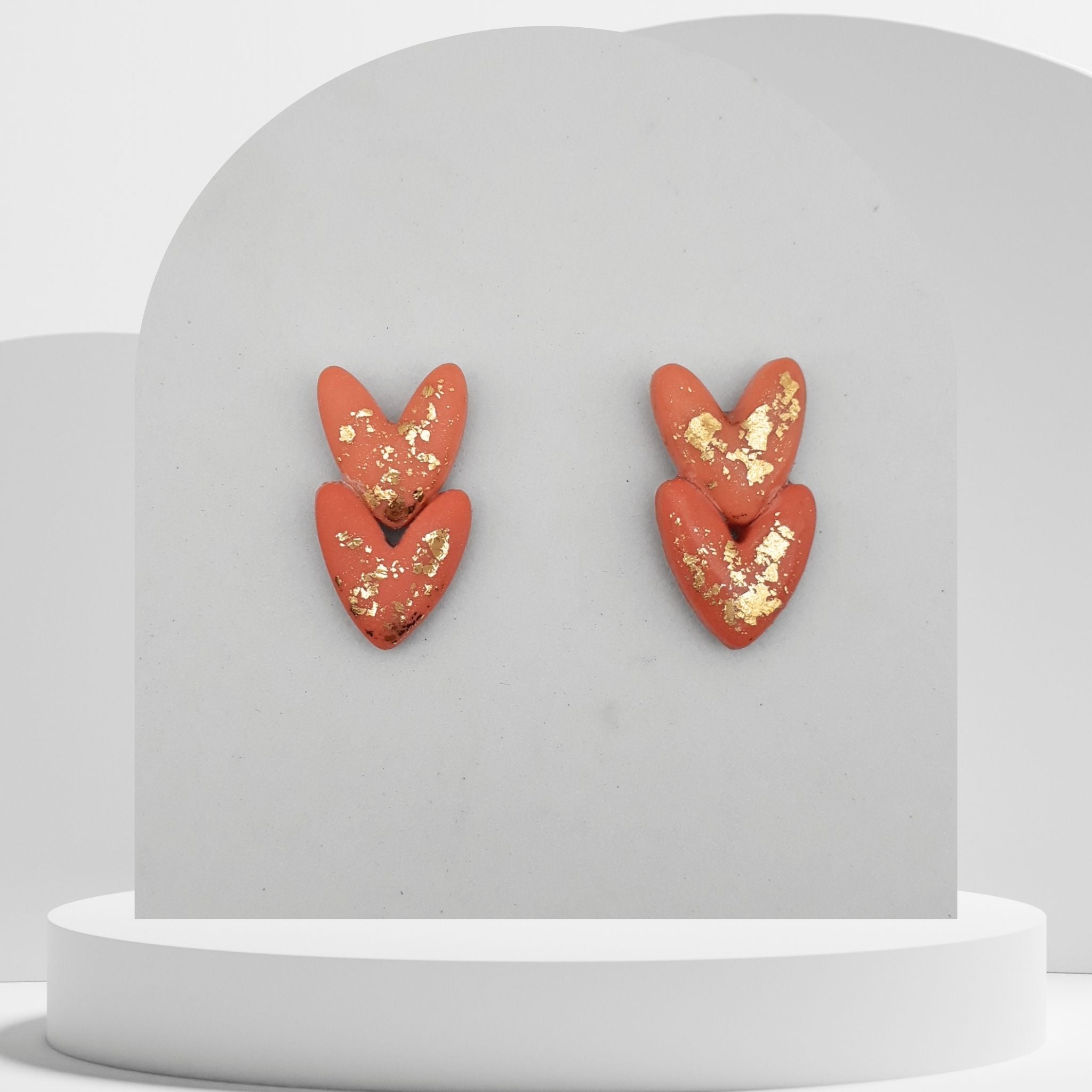 Salmon pink double heart polymer clay stud earrings with gold leaf and stainless steel pins