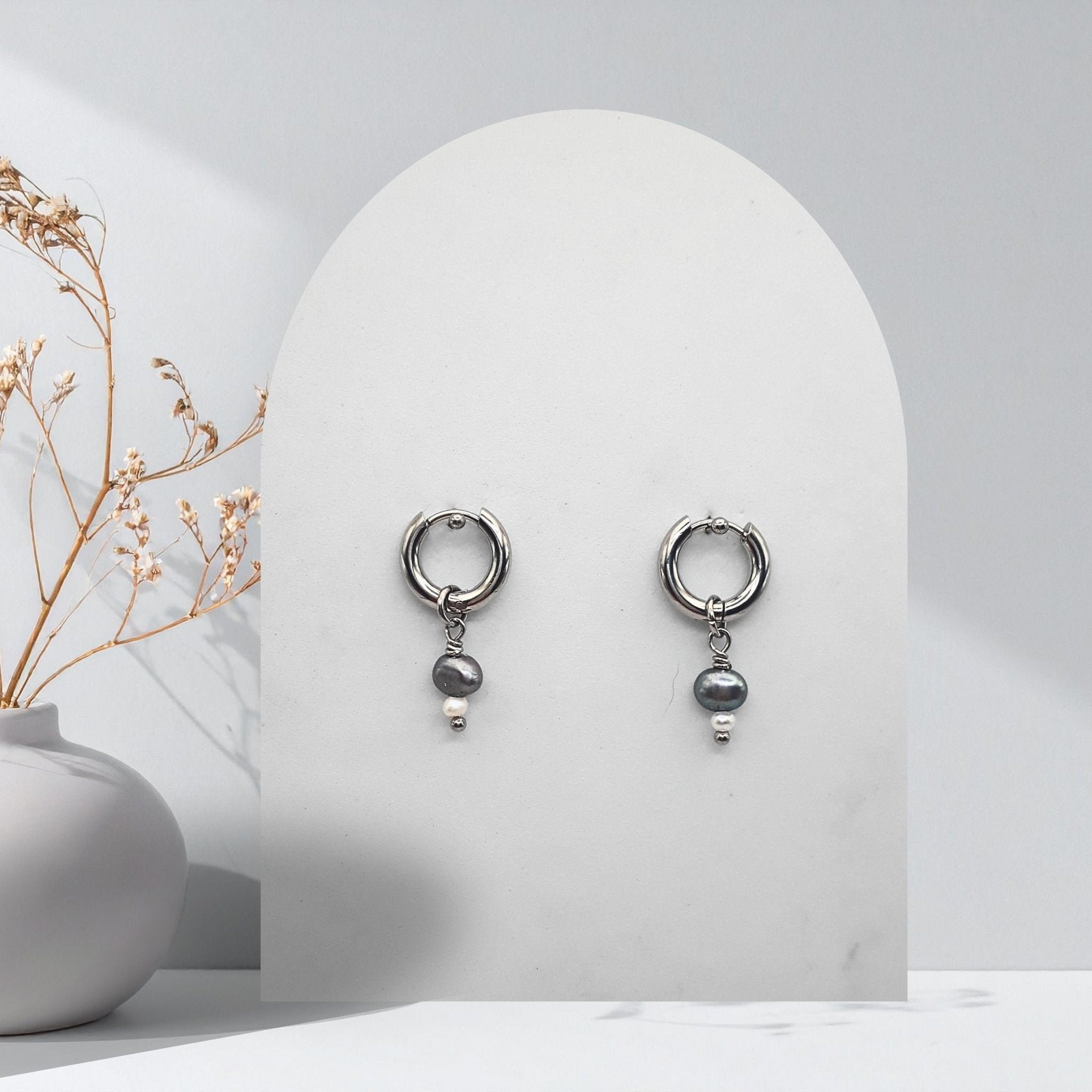 Handmade 316L stainless steel 12 mm huggie hoop earrings with removable natural silver and white freshwater rice pearl charms.