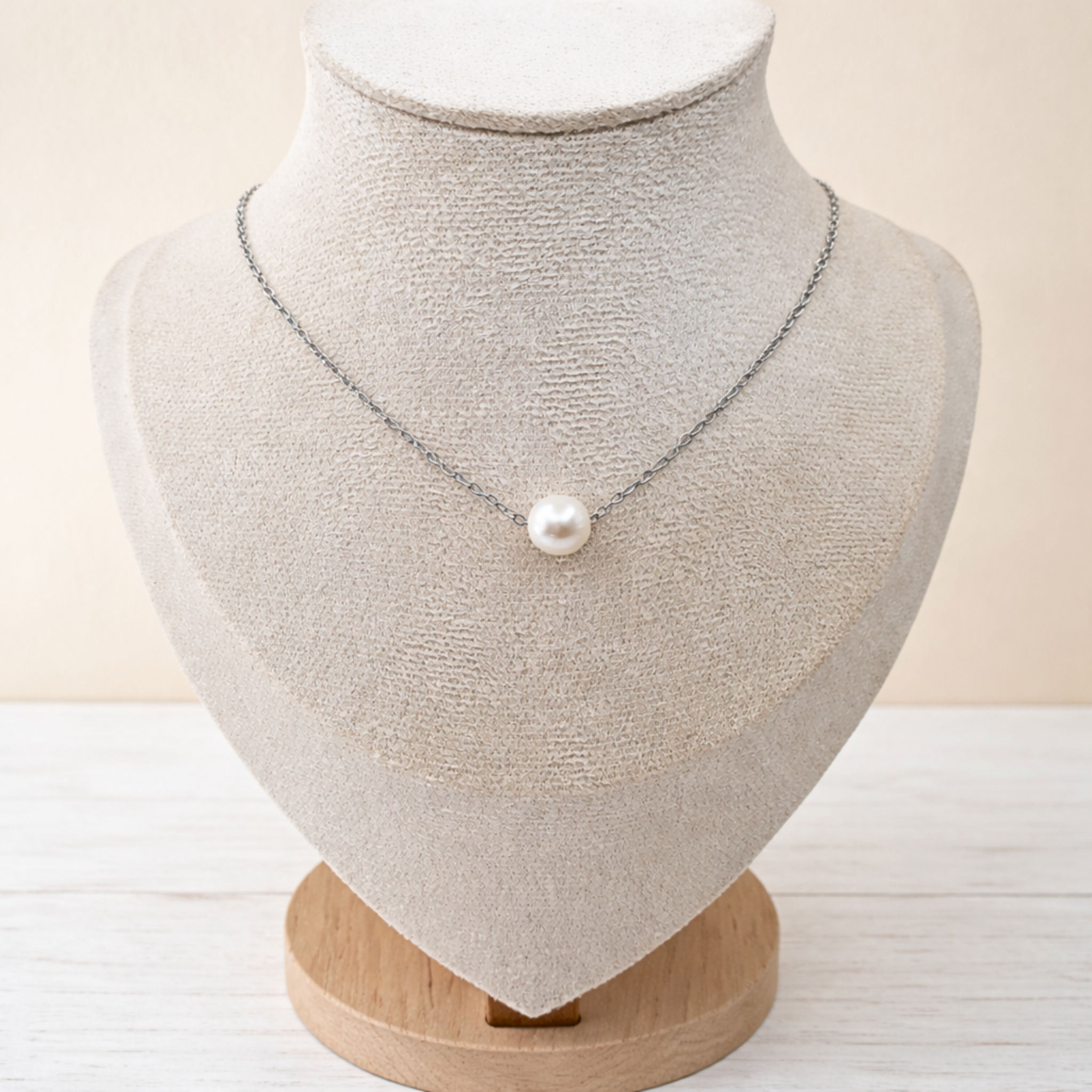 Single 7 mm freshwater pearl floating necklace on stainless steel chain with lobster clasp.
