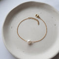 Handmade 304 gold-plated stainless steel bracelet with one 7mm natural white freshwater pearl on a cable chain with lobster clasp.