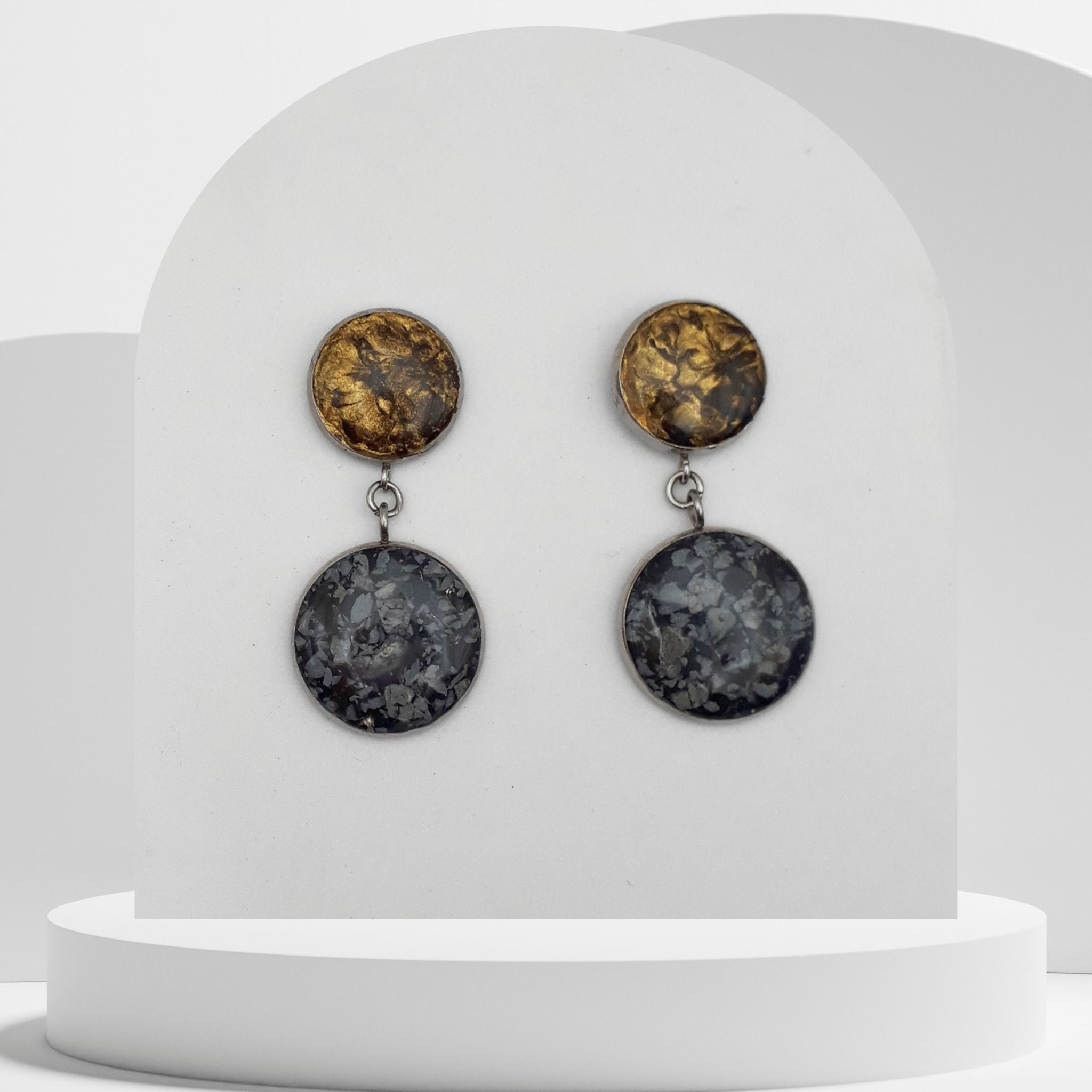 Stainless steel drop earrings with 18mm snowflake obsidian bezel and 14mm gold leaf bezel stud, sealed in resin