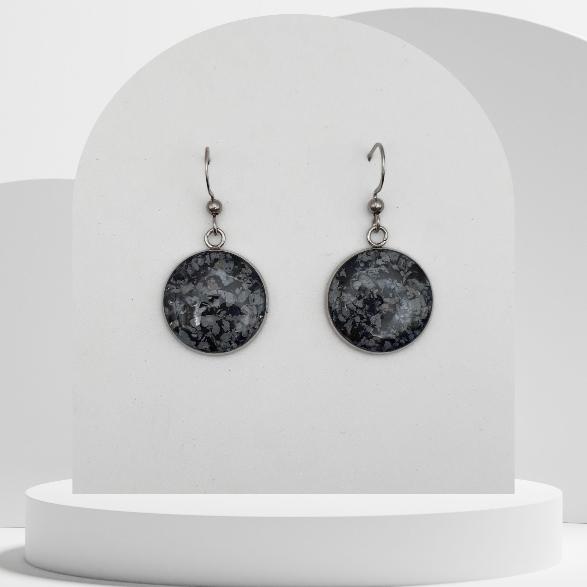Stainless steel drop earrings with 18mm bezel set crushed snowflake obsidian gemstones sealed in resin on shepherd hooks