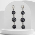 Stainless steel triple dangle earrings with 10mm, 12mm and 10mm bezel set crushed snowflake obsidian gemstones and leaf stud design