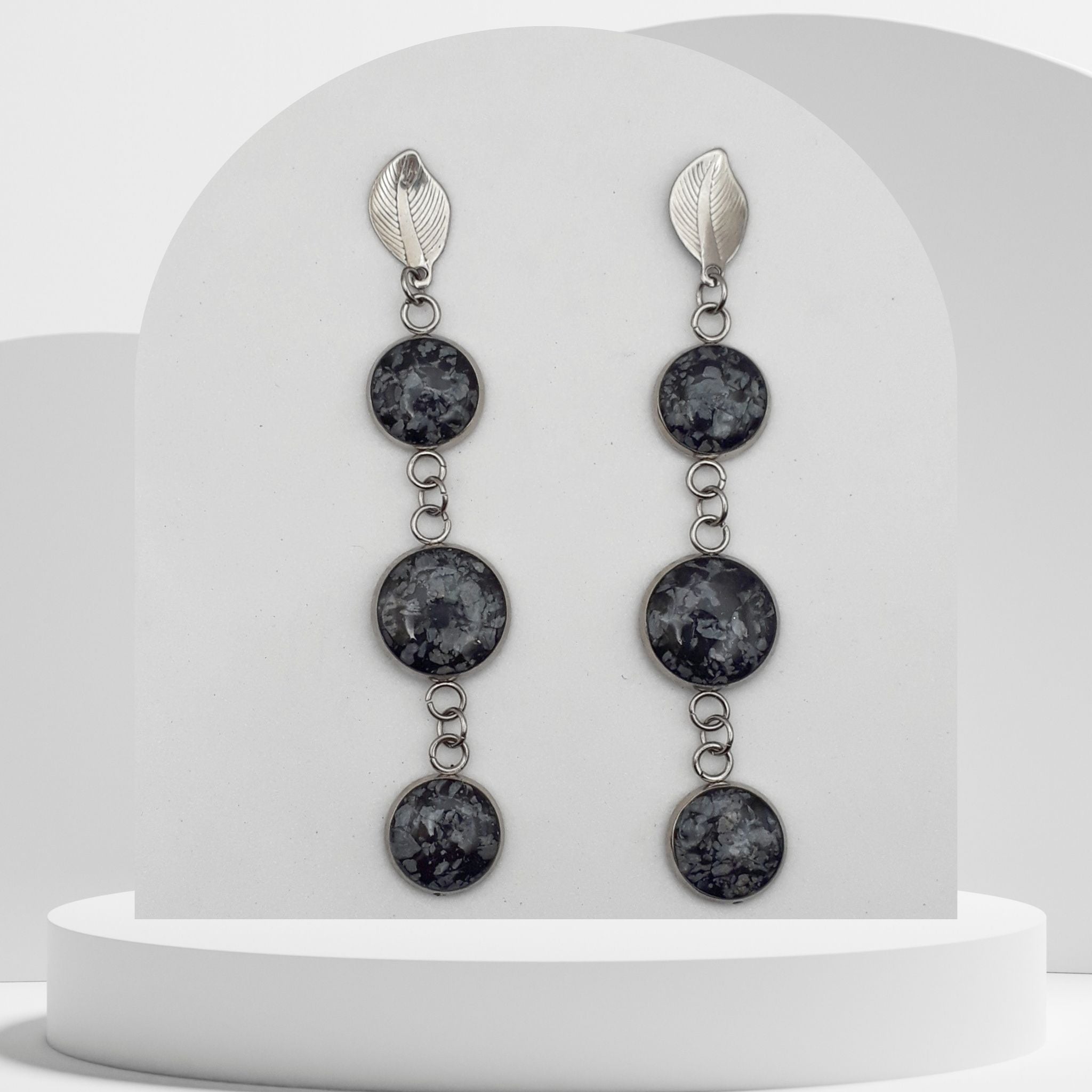 Stainless steel triple dangle earrings with 10mm, 12mm and 10mm bezel set crushed snowflake obsidian gemstones and leaf stud design